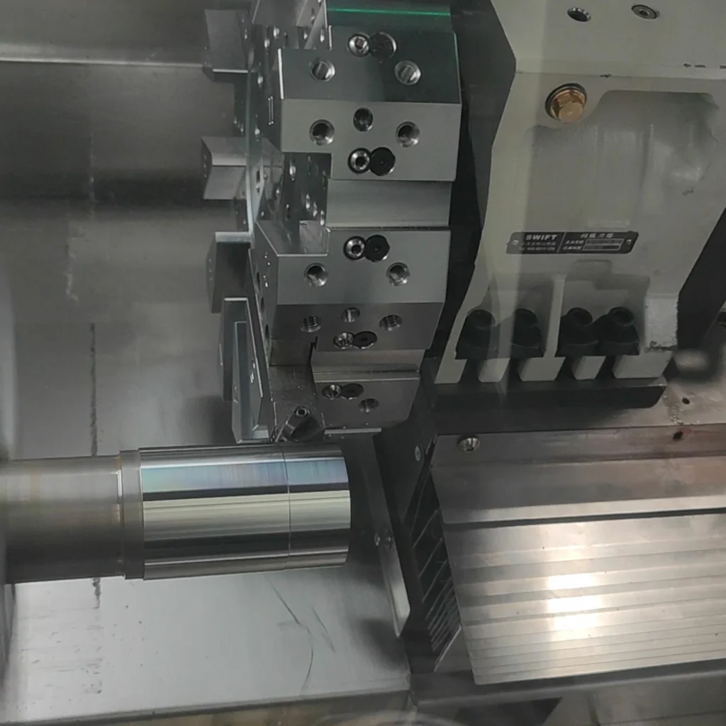 Slant bed CNC lathe test running with metal bar before delivery